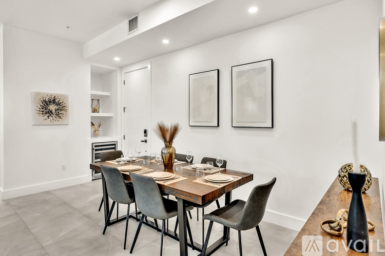 A dining room with a wooden table and chairs.