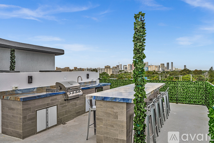 A modern house with a pool and a tall green plant in the foreground.