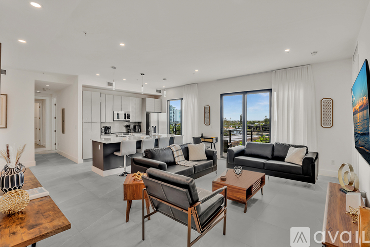 A modern living room with a large window and a view of the city.