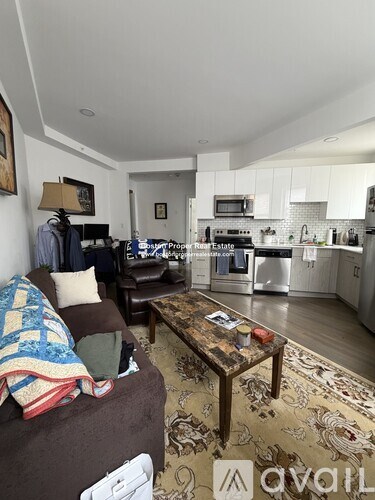 A living room with a brown couch and a coffee table.