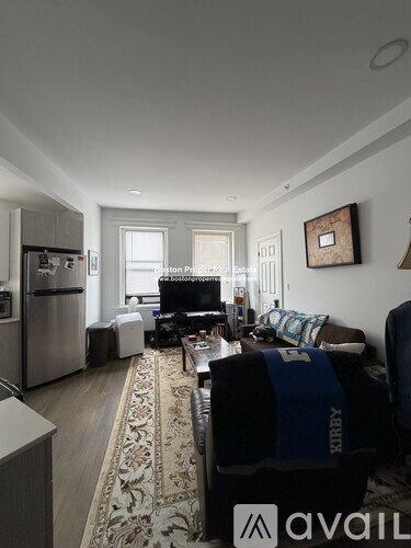 A living room with a couch and a rug.