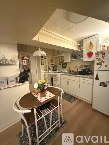 A kitchen with a table and chairs in the middle of it.
