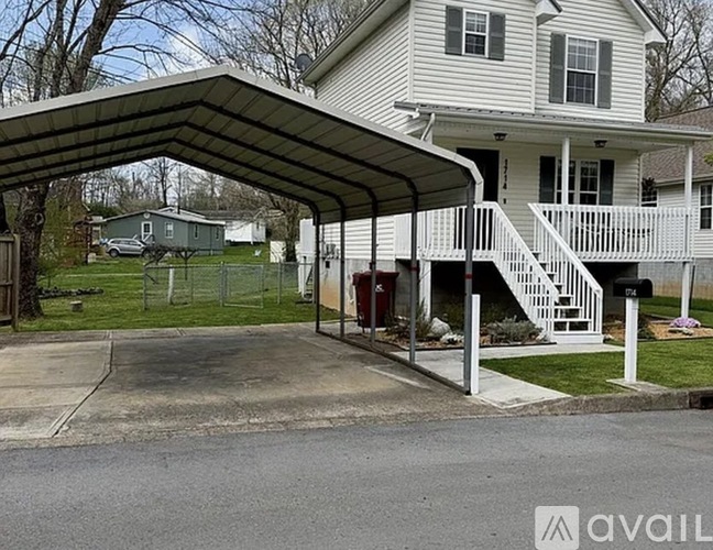 A house with a covered porch and a driveway.