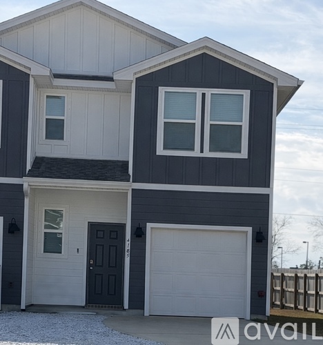 A two-story house with a garage on the lower level.