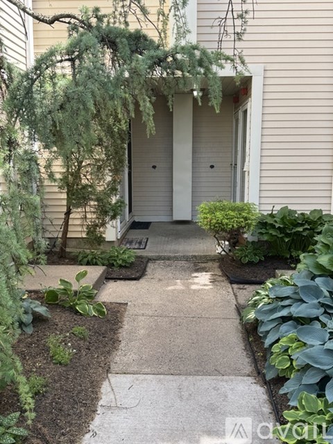 A white door is on the right side of a house.