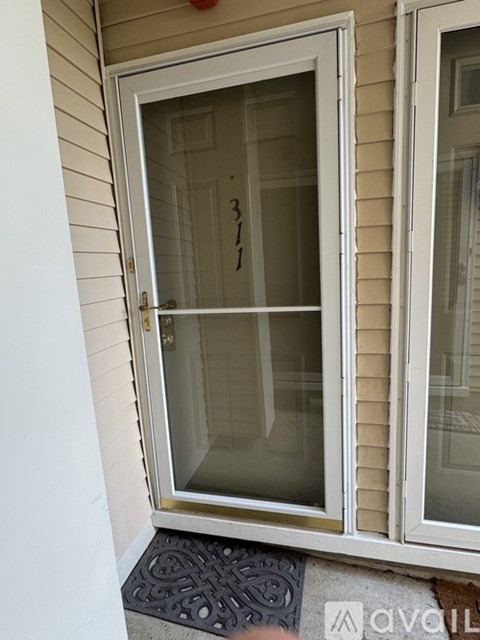 A hallway with a door leading to a balcony.