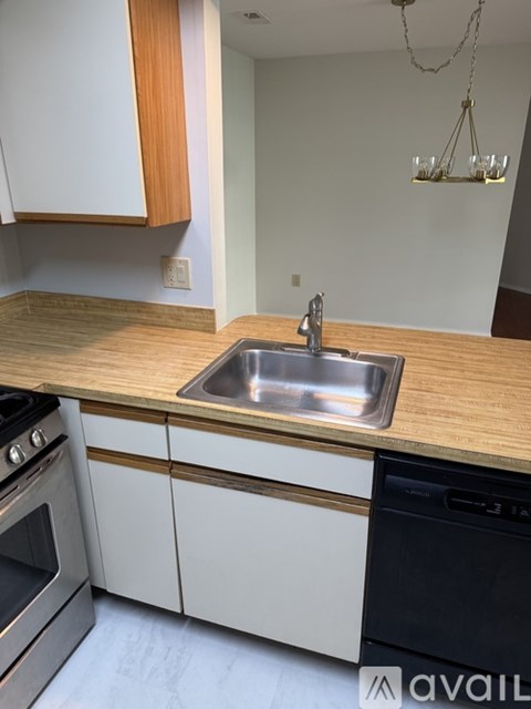 A kitchen with a sink and a stove.