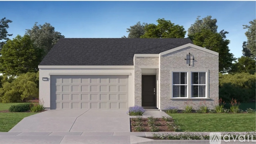 A modern house with a garage door and a cross on the wall.