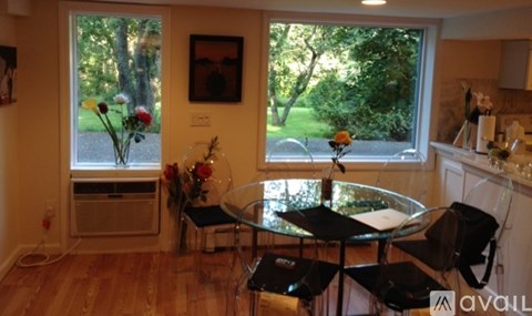 A dining room with a glass table and chairs.