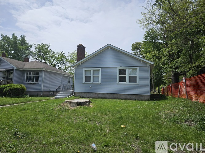 A blue house with a white fence in front.