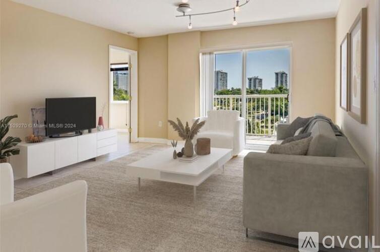 A living room with a white sofa and a television.
