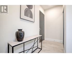 A room with a table and a vase on it.