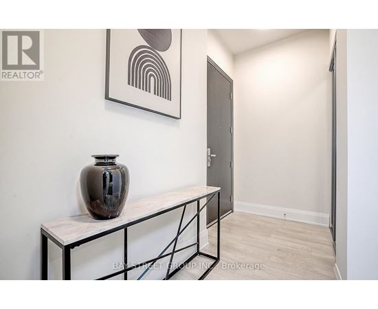 A room with a table and a vase on it.