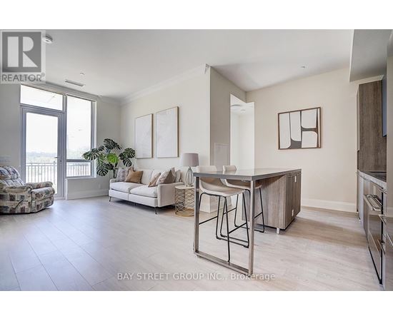 A spacious living room with a dining table and chairs.