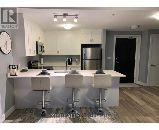 A modern kitchen with white cabinets and a central island.