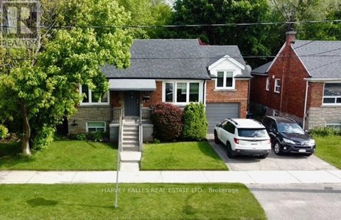 A house with a car parked in front of it.