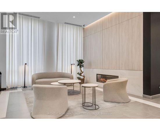 A modern living room with a fireplace and comfortable seating.