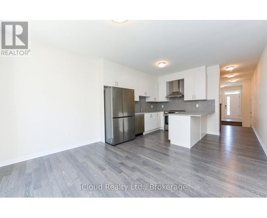 A spacious kitchen with white cabinets and a central island.