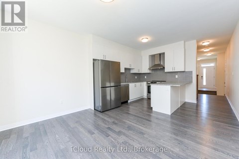 A spacious kitchen with white cabinets and a central island.