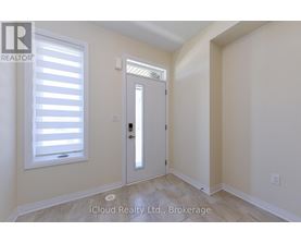 A room with a door and a window with blinds.