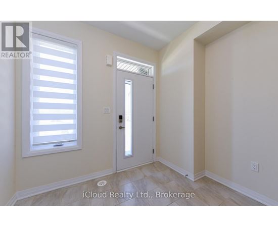 A room with a door and a window with blinds.