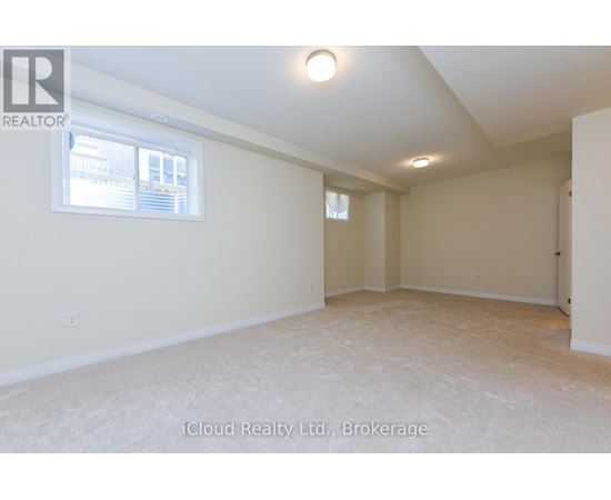 A spacious room with a window and a door on the right side.