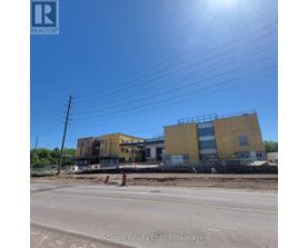 A building under construction with a clear blue sky above.