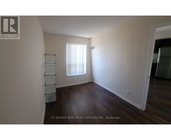 A room with a window and wooden floors.
