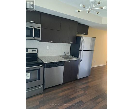 A kitchen with a stainless steel refrigerator and microwave.