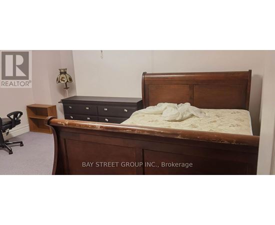 A bed with a wooden headboard and footboard with a mattress on top of it.