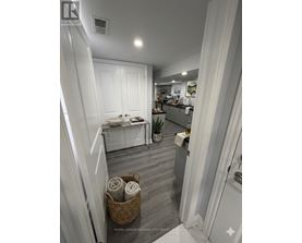 A bathroom with a white toilet and a white sink.