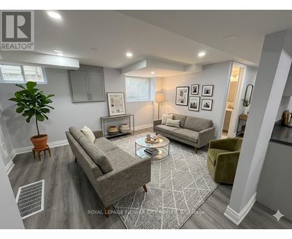 A living room with a grey sofa and a green armchair.