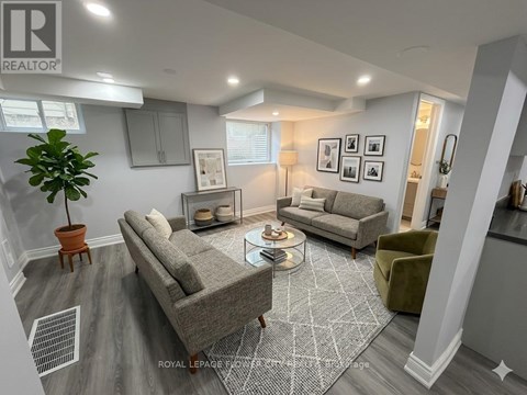 A living room with a grey sofa and a green armchair.