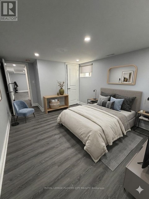 A bedroom with a bed, a chair, and a mirror on the wall.