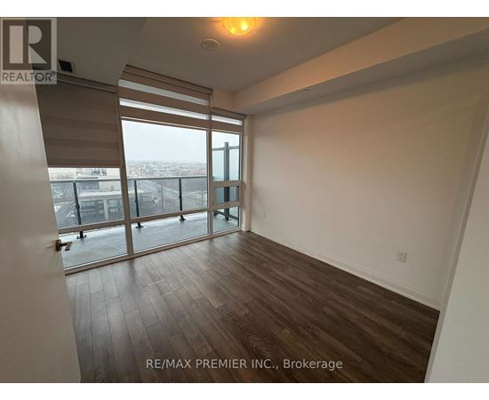 A room with a view of the city through large windows.