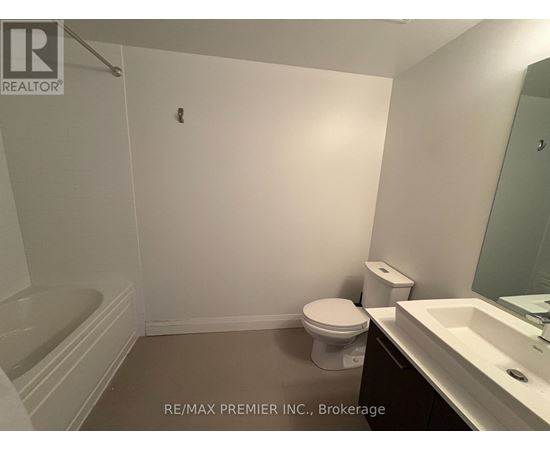 A bathroom with a toilet, sink and bathtub.