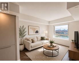 A living room with a white couch, a coffee table, and a window with a view of the city.