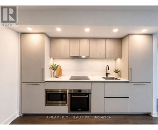 A modern kitchen with a stainless steel oven and microwave.