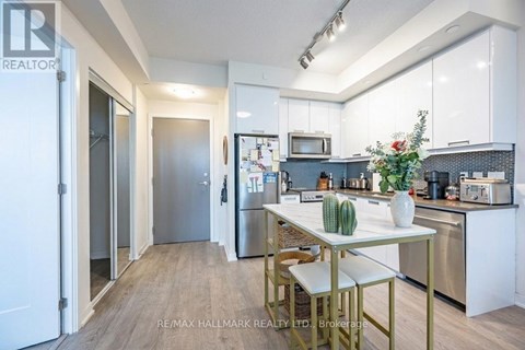 A kitchen with a table and chairs in the middle of it.