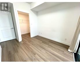 A room with wood flooring and white walls.
