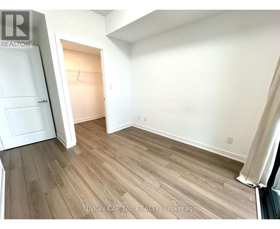 A room with wood flooring and white walls.