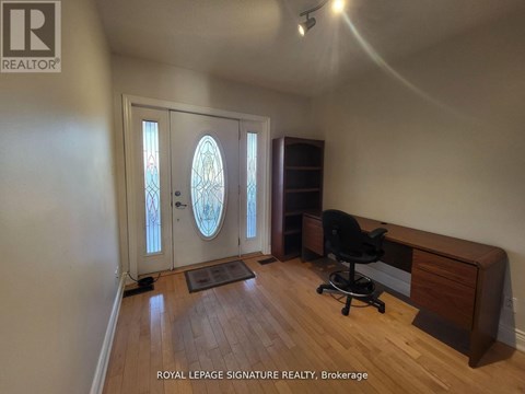 A room with a desk and a chair in it.