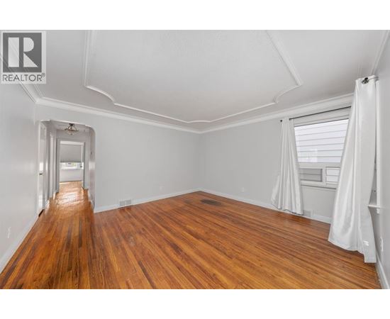 A room with wooden floors and white walls.