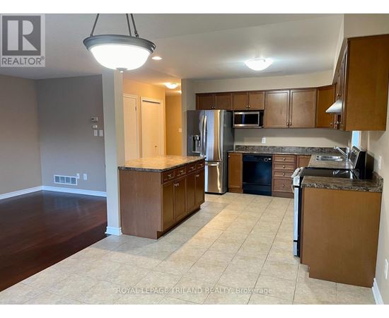 A kitchen with brown cabinets and a countertop.