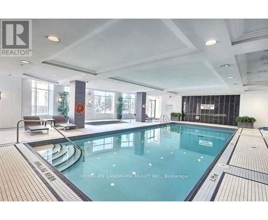 A large indoor swimming pool with a tiled edge and a small pool area to the left.