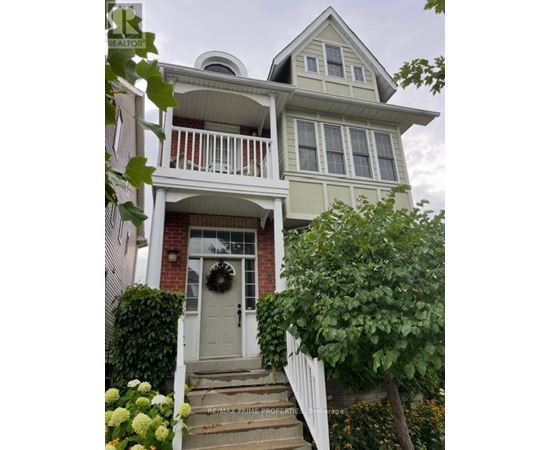 A house with a grey front door and a wreath on it.