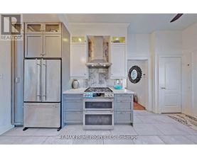 A kitchen with a stainless steel refrigerator and oven.