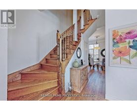 A staircase with a wooden banister and steps.