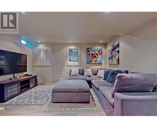 A living room with a grey couch and a television.