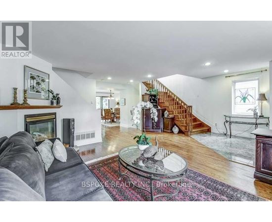 A living room with a grey couch and a coffee table in the middle.
